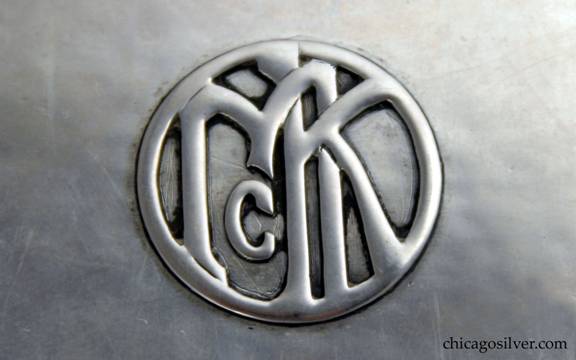 Kalo box, cigarette, rectangular with hinged cover and slightly rounded corners.  Applied "McK" mono in circular cartouche on cover.  Detail shown.