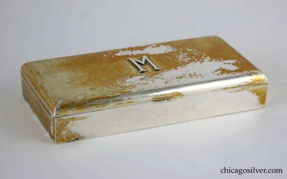 Kalo box, silver, rectangular, with flat lid that has curved edges, on long hinge.  Applied M on lid.  