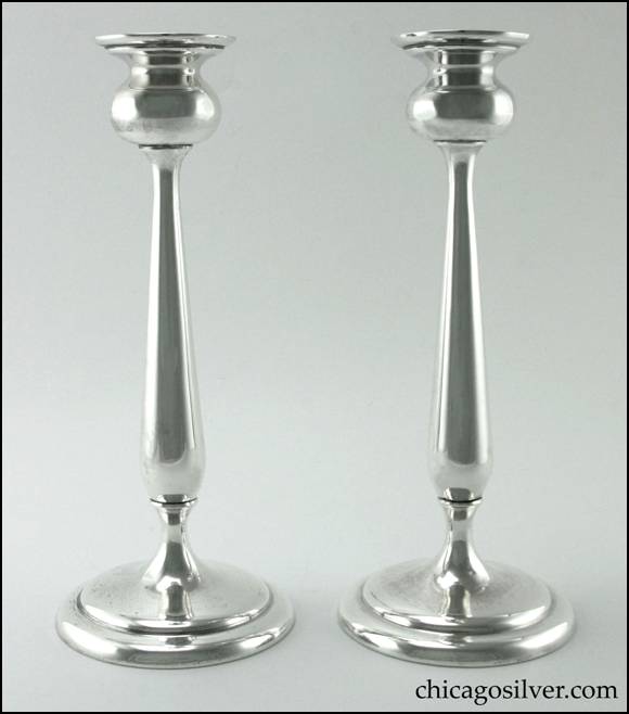 Edward H. Breese candlesticks, pair (2), tall tulip form, with flaring bulb-shaped cups, tapered stems widening at the bottom, and round gently stepped bases.  

