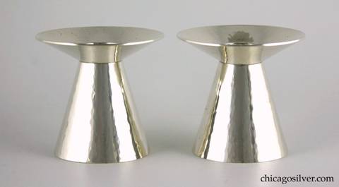 Kalo candlesticks, pair (2), with flared cone-shaped bodies tapering to wide upturned round wax catches each centering a small cylindrical bobeche.  Modern styling.  Very heavy.  Lovely hammering.  Pristine unused condition.  3-1/6" W and 2-7/8" H.  Marked:  STERLING / HAND WROUGHT / AT / THE KALO SHOP / C11