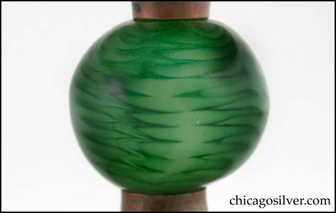 Detail from Rebecca Cauman compote, copper, with flaring round top and foot joined by a large green glass ball with internal black design.  