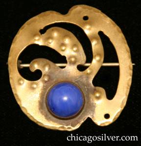Forest Craft Guild brooch, brass, with notches top and bottom, three curving cutouts at center, two pierced holes around edge, numerous small repousse round domes, and round blue bezel-set cabochon stone at bottom.  