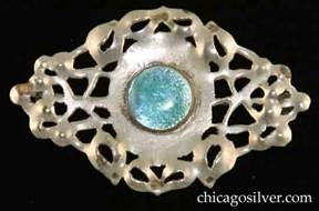 Forest Craft Guild brooch, German silver, oval / diamond shaped with irregular edge, and numerous irregular saw-pierced holes framing a central round bezel-set iridescent blue-green glass cabochon stone.