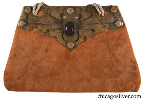 Forest Craft Guild handbag, ooze leather, lined, trapezoidal, with riveted cutout and repousse brass hardware at top centering an oval purple bezel-set stone on each side.  Original twisted cord handle.  