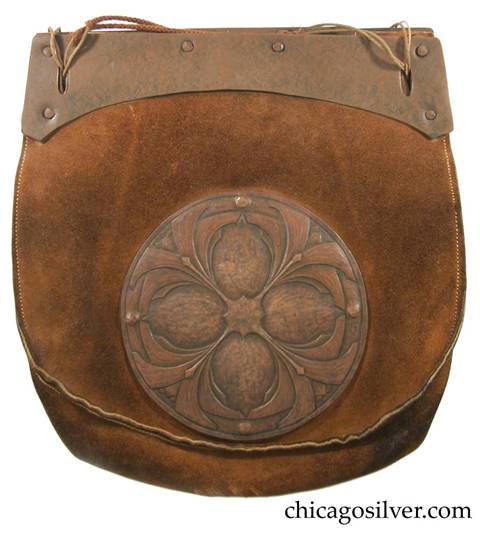 Forest Craft Guild handbag, ooze leather, with flat top and rounded body and curved copper hardware at top plus separate large riveted round very detailed and elaborate repousse copper decoration below one front with geometric floral design.  Original braided cord handle.  