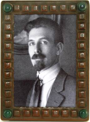 Forest Mann, shown in rare Forest Craft Guild copper picture frame
with repouss squares and green bezel-set cabochons at the corners