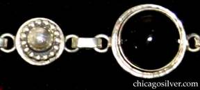 Detail of Laurence Foss bracelet with round black bezel-set cabochon onyx stones 