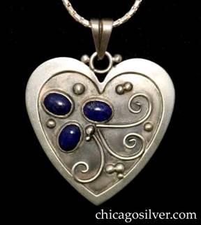 Laurence Foss pendant on chain, in the form of a heart, with raised border, oxidized background, and three oval bezel-set cabochon lapis stones and curving bead and wirework.