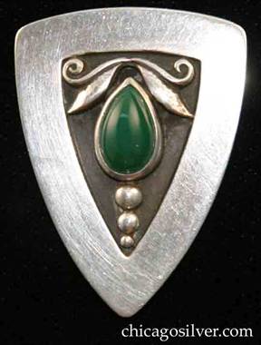 Foss brooch / pendant with green stones.  Triangular brooch with curved corners and edges, loop on back for use as pendant, triangular inset at center with oxidized background with applied leaves and scrolls on top, row of three vertical beads at bottom, centering tear-shaped bezel-set green cabochon stone.