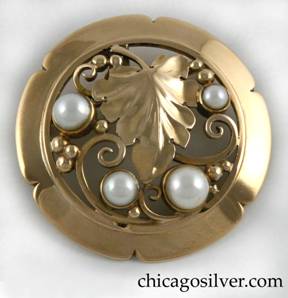 Laurence Foss brooch, gold, round, with pearls.  Round frame with six rounded notches centering a large detailed leaf, surrounded by openwork spirals and beads, and four round bezel-set pearls.  Very much in the style of Edward Oakes.