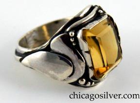 Laurence Foss ring, silver, with large rectangular bezel-set open-back citrine, with a curving applied leaf on one side, a tulip blossom on the other, tiny beads and wire decoration around the stone, and larger beads and a thicker applied wire that runs around the back of the shank.