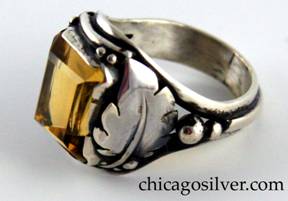 Laurence Foss ring, silver, with large rectangular bezel-set open-back citrine, with a curving applied leaf on one side, a tulip blossom on the other, tiny beads and wire decoration around the stone, and larger beads and a thicker applied wire that runs around the back of the shank.