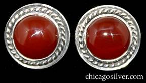 Laurence Foss earrings, pair (2), for pierced ears, round button-form, each with twisted ropelike frame centering a round bezel-set cabochon carnelian stone.  Small pin extending from center of back.  