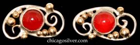 Laurence Foss earrings, pair (2), for pierced ears, small.  Oblong silver curving wirework frame with eight applied gold beads, centering a round bezel-set cabochon carnelian stone.  