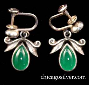 Laurence Foss earrings, pair, screw-back, with teardrop-shaped green bezel-set stones below hammered leaves and scroll decoration.