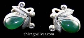 Laurence Foss earrings, pair, screw-back, with teardrop-shaped green bezel-set stones below hammered leaves and scroll and bead decoration.
