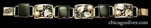 Laurence Foss bracelet, with pearls.  Three rectangular convex open links each with leaves, silver beads, wirework scrolls, and a large round bezel-set pearl, alternating with three narrow rectangular bezel-set onyx links.  Additional applied beads and wirework scroll on a separate clasp.   Very much like the work of Oakes.  
