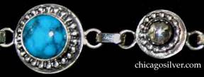 Detail from Laurence Foss bracelet, with seven alternating links of four round bezel-set cabochon turquoise stones.