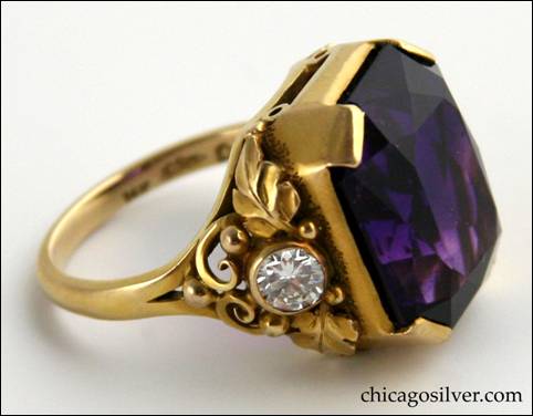 Gilbert Oakes gold ring with central faceted amethyst with deep color, flanked by bezel-set diamonds