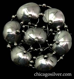 Mary Gage pin, round, composed of a circle of six chased lily pads surrounding a central lily pad