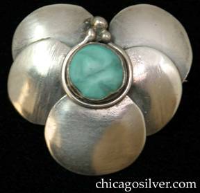 Lillian Pines brooch / pin, composed of five overlapping circles in a heart-shaped arrangement, centering a carved bezel-set turquoise stone with a decorative wire around the bezel and three small beads on top.
