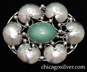 Lillian Pines brooch / pin, oval, composed of six chased lily pads surrounding a central bezel-set oval green speckled aventurine cabochon stone, with applied beads and vines on an oval frame with underlying irregular wirework supports.