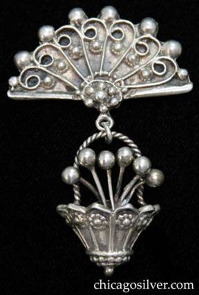 Lillian Pines brooch / pin, fan-shaped with drop made of small 3-dimensional ornamented bucket containing bead-like flowers with flowers and beads on the side and twisted rope handle.
