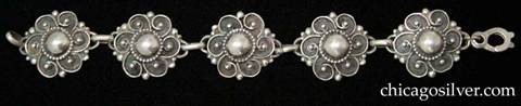 Lillian Pines bracelet, composed of five round floral links each centering a silver dome ringed with beads and six spirals that each end with a central bead.