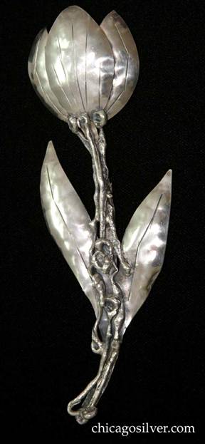 Mary Gage pin, extremely large, in the shape of a chased and repousse flower with two long, thin leaves on a twisted, irregular applied stem