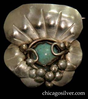 Mary Gage pin, made of three stacked chased lily pads, centering a round, bezel-set turquoise stone also secured by silver loops ending in beads