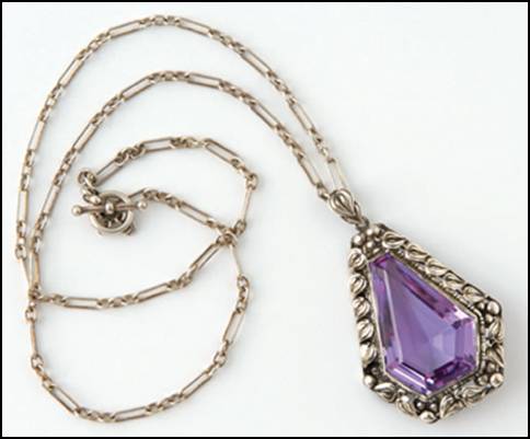 Pendant, 2" H, on silver chain 19" L.  Handwrought in sterling silver by James Scott of the Elverhj craft community, with elegantly fashioned leaves and beadwork forming a border around a central teardrop-shaped faceted amethyst.  Unsigned.