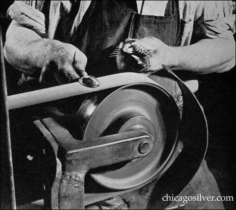 POLISHING -- The flatware which has been stamped with the desired design on handle and bowl is being polished on an emery belt
