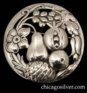 Randahl brooch, round, with chased and cutout blossoms, leaves, and fruit on a slightly convex circular frame.  One of the largest and nicest executions of a Randahl pin that we've seen.  