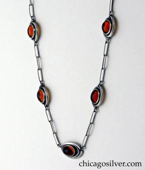 Kalo necklace on paperclip chain with seven amber plaques.   