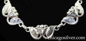 Kalo necklace / choker composed of ten links, each centering a stylized flower with three beads at the top, and two vines that curve up from the bottom to support a leaf on each side 