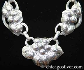 Kalo necklace / choker, composed of 11 links in the form of blossoms with cutout "ears" that hold small loops which join the necklace together