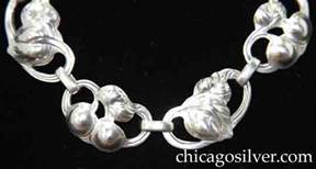 Kalo necklace / choker composed of 13 chased, repousse, and pierced oval links joined by single links.  Links alternate between 7 with a single leaf and two cherries, and 6 with two leaves.   Comes in set with matching bracelet.