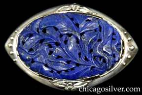 Kalo brooch / pendant, oval, with thin frame with applied flowers, leaves, and beads at the top, bottom, and ends, centering a large carved and saw-pierced dark blue oval lapis stone.  