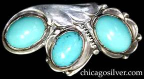 Kalo clip, dress, with three large oval cabachon oval turquoise bezel-set stones with floral, frames below free-form wing shape, with graduated beaded row separating two of the frames.  