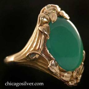 Kalo ring, gold, with large green oval cabochon chrysoprase bezel-set stone, and leaf and berry ornament at top and bottom 