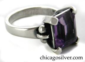 Kalo ring, handwrought in sterling silver with large rectangular cut amethyst in a prong setting with a bar and ball decoration on shank, flanking the stone on either side.