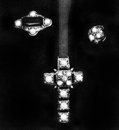 Elaborately wrought cross finished on both sides: suspended  on black ribbon; brooch of simple design; ring of baroque pearls, by Edward E. Oakes 
