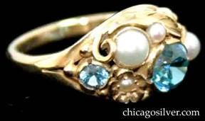 Ring, by Edward Oakes, 18K yellow gold with blue faceted zircons and pearls on large and lovely gold leaf background, with scrolls and beads
