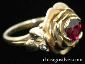 Ring, by Edward Oakes, pink gold, rose petal motif, centering 1.45 carat faceted ruby inside nest of petals, and accented with a small diamond and leaves and beads on each side.