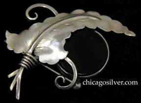 Brooch, by Gilbert Oakes, hand wrought in sterling silver with large central leaf with applied vein and chased details with round, black onyx disk.  Bead and wire work.
