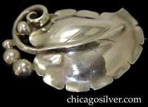 Brooch, by Gilbert Oakes, hand wrought in sterling silver with large central leaf with applied vein and chased details.  Bead and wire work.