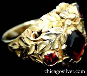 Ring, by Susan Oakes Peabody, hand wrought in 14K gold with three faceted garnets with deep red color and two small diamonds.  The stones are set among fine, highly detailed gold work depicting leaves, scrolls and small beads.  The diamonds are set inside gold flower blossoms.  Beautifully crafted, heavy.