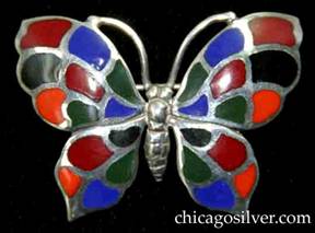 Kalo brooch, butterfly-form, with detailed insect body and antennae surrounded by four-part wings decorated with cloisonn enamel cells in blue, orange, black, red, and green colors