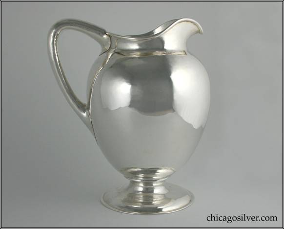Kalo pitcher, smooth surface on low ring foot, bulbous body, applied wire on rim and nice angular hollow handle.  8" W and 9-3/4" H.  STERLING / HAND WROUGHT / AT / THE KALO SHOPS / CHICAGO / 9305