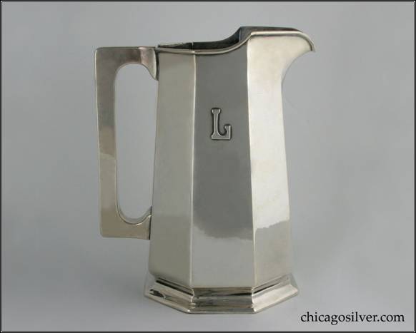 Kalo pitcher, water, gently tapering paneled form with flat top and bottom square section hollow handle, rising spout, on small foot, with applied "L" mono, engraved "January 10, 1914" on bottom, applied wire to rim.  Excellent condition, fine hammering.  From the estate of Ruth Langworthy.  9-9/16" H and 7-7/8" W.  STERLING / HANDWROUGHT / AT / THE KALO SHOP / G579